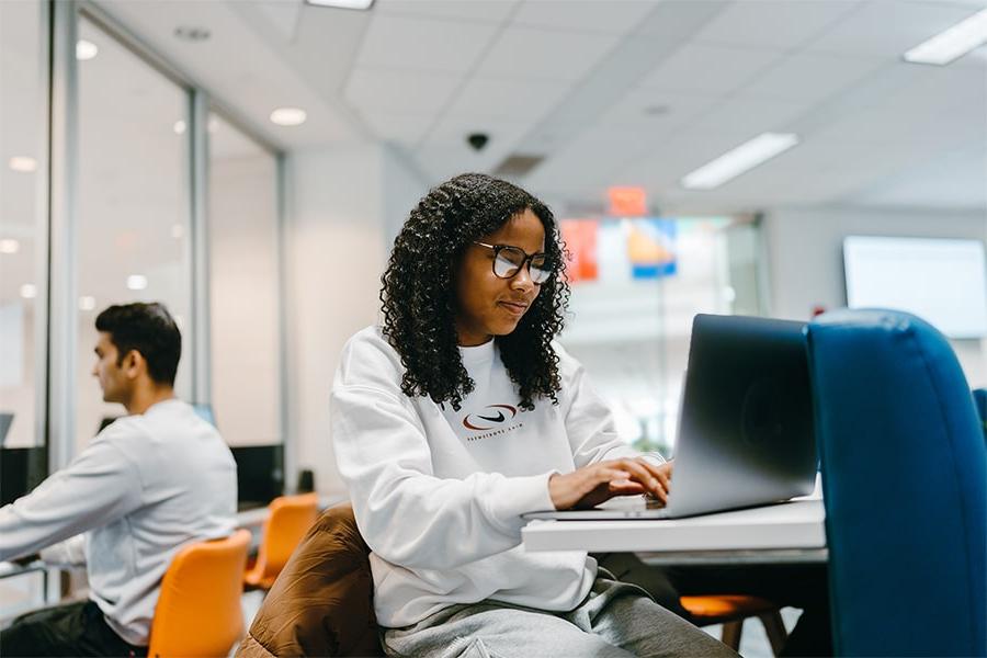 student on laptop in One Stop office