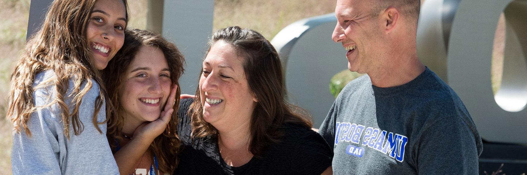 parents embrace enrolled UMass Boston Student on Move In Day